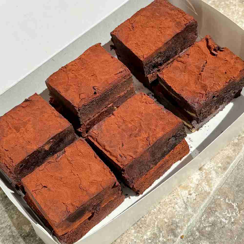 Fudgy gluten free chocolate brownies in a white box.