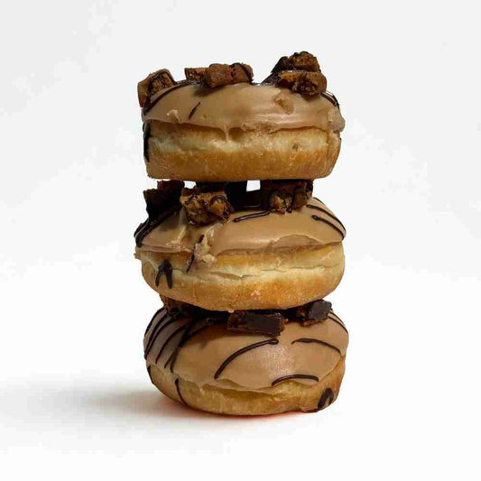 Deluxe caramel slice doughnut stacked.