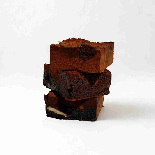 Fudgy chocolate brownies stacked.