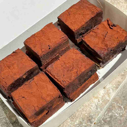 Fudgy gluten free chocolate brownies in a white box. 