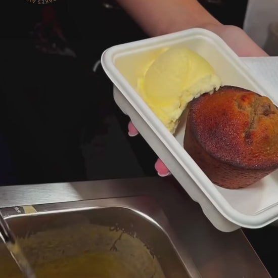 Video of sticky date pudding and vanilla ice cream being topped with warm butterscotch sauce. 